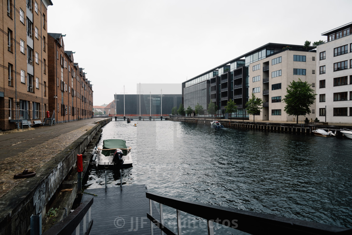 "Port of Copenhagen with boats moored against old and new buildin" stock image