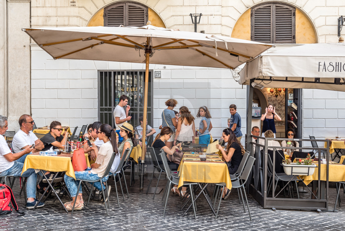 "Sidewalk restaurant with tourists in Roman square a sunny summer" stock image