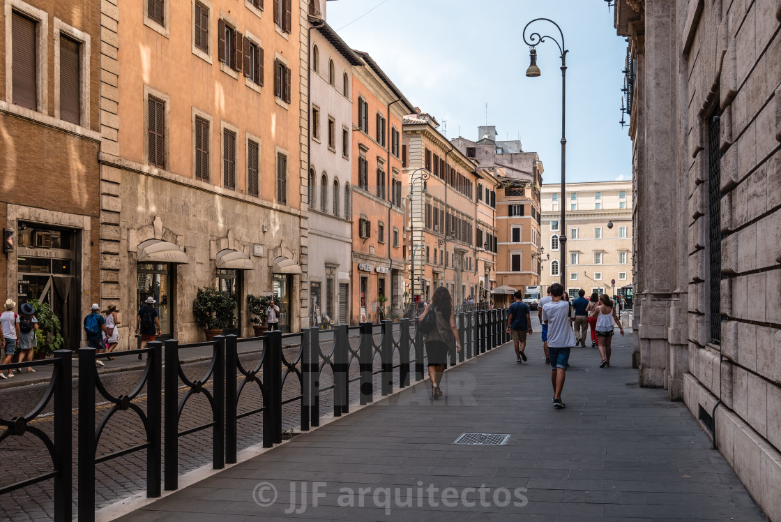 "Tourists in traditional street in the historical centre of Rome." stock image