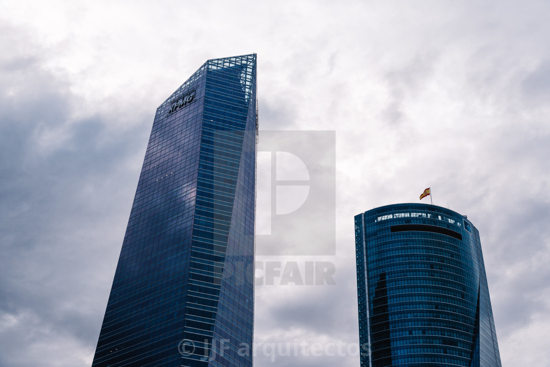 "Low angle view of skyscraper in business district against sky" stock image