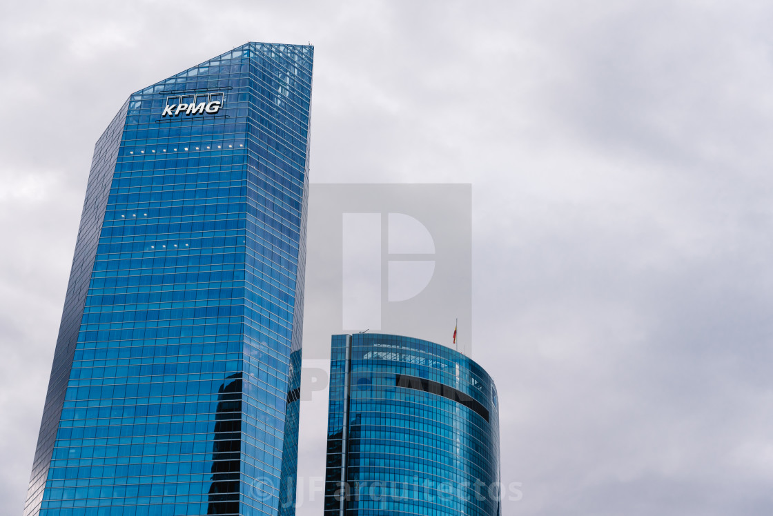 "Low angle view of skyscraper in business district against sky" stock image