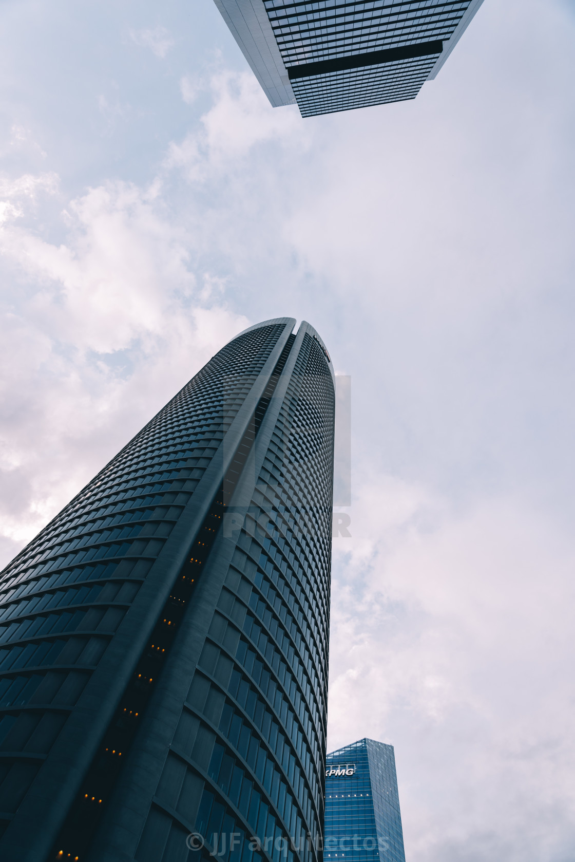 "Low angle view of skyscraper in business district against sky" stock image