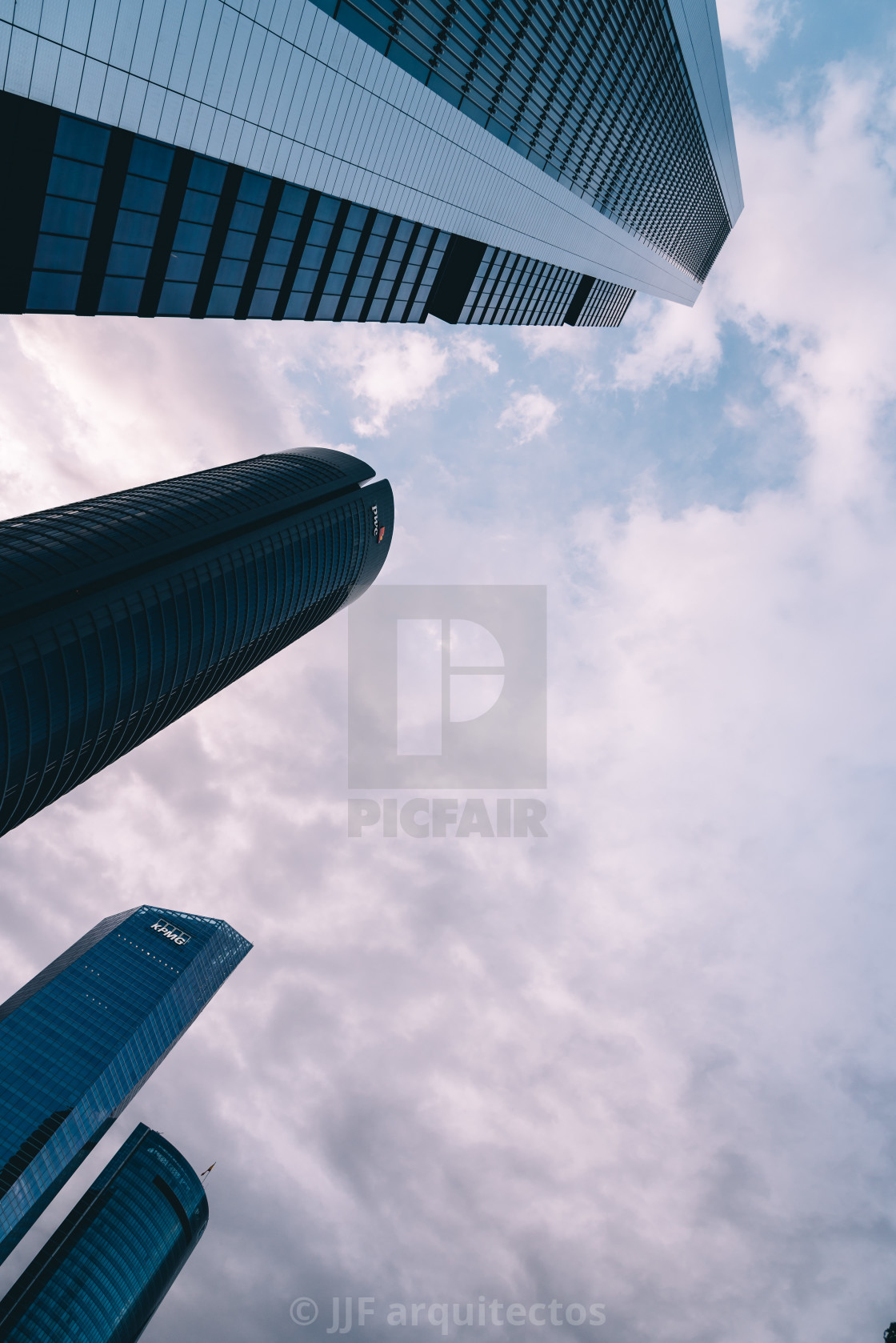 "Low angle view of skyscraper in business district against sky" stock image