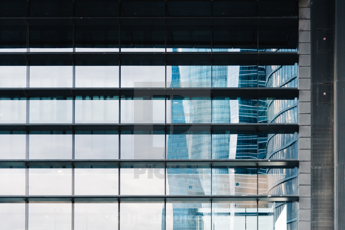 "Reflections on facade of skyscraper in business district" stock image