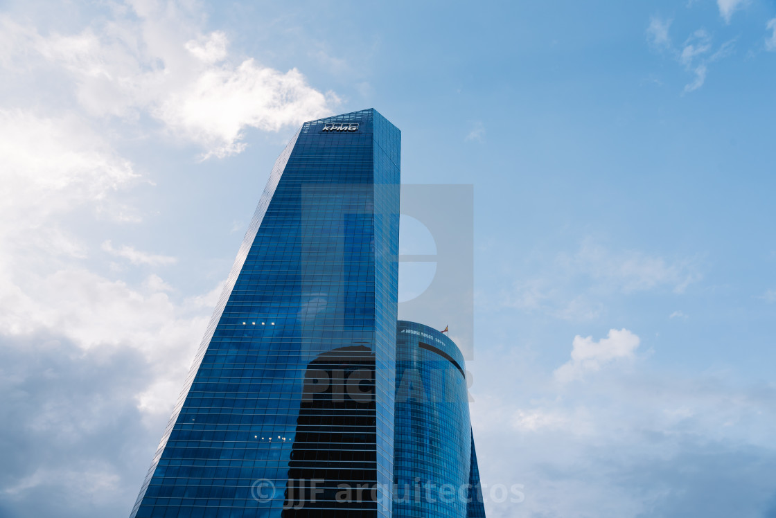 "Low angle view of skyscraper in business district against sky" stock image