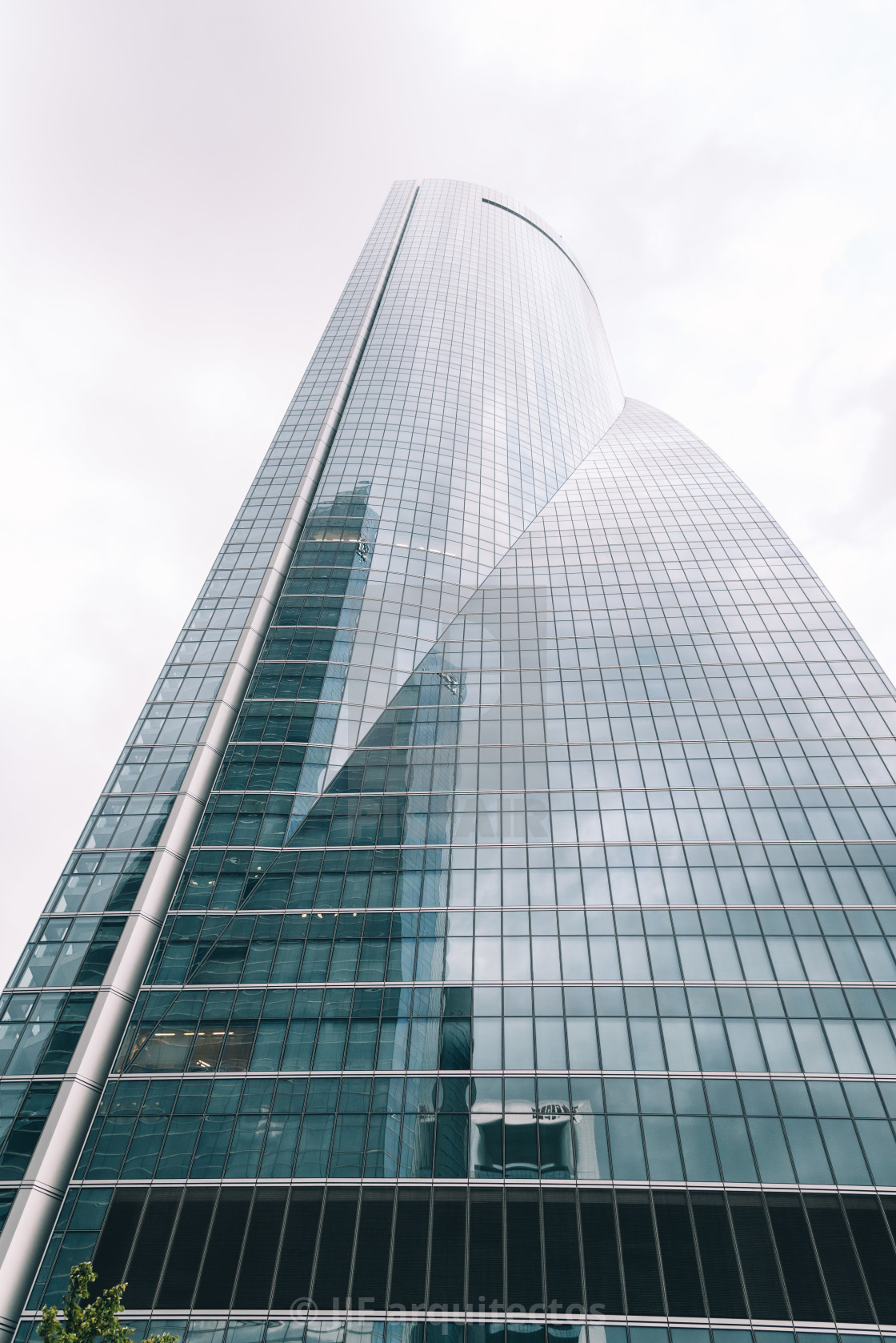 "Low angle view of skyscraper in business district against sky" stock image