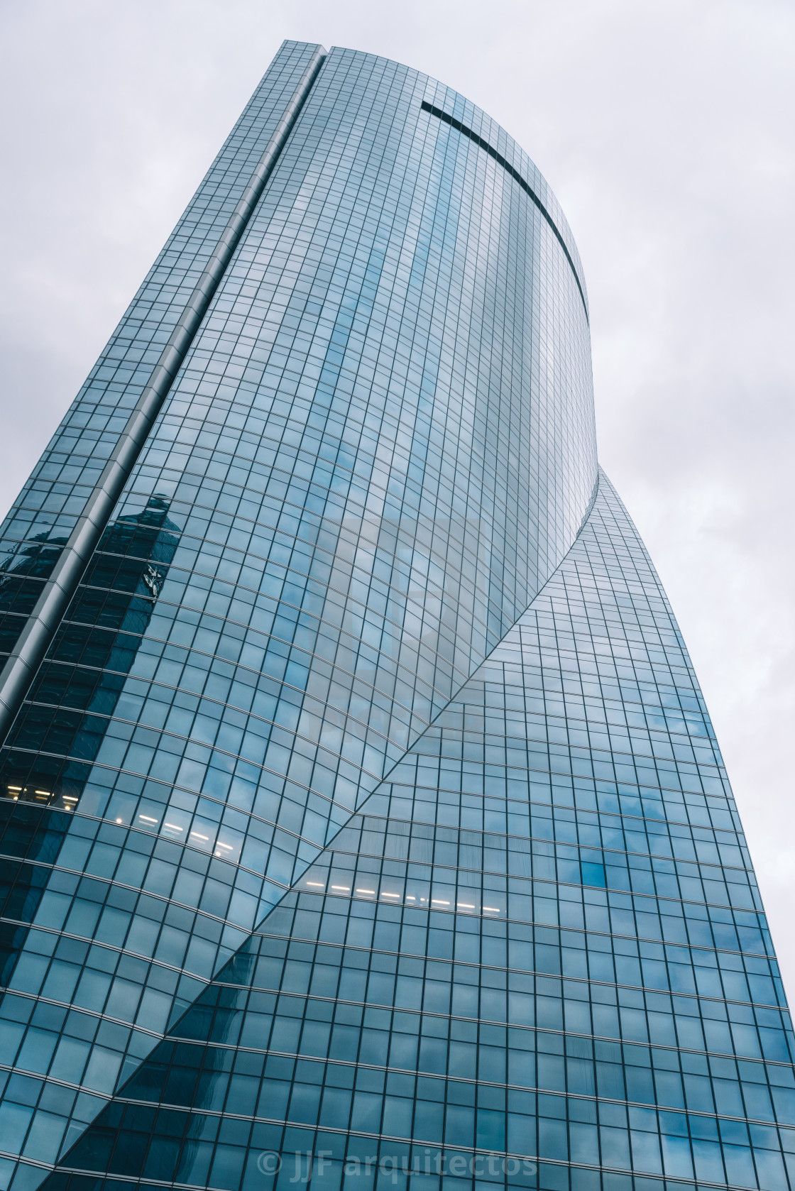 "Low angle view of skyscraper in business district against sky" stock image