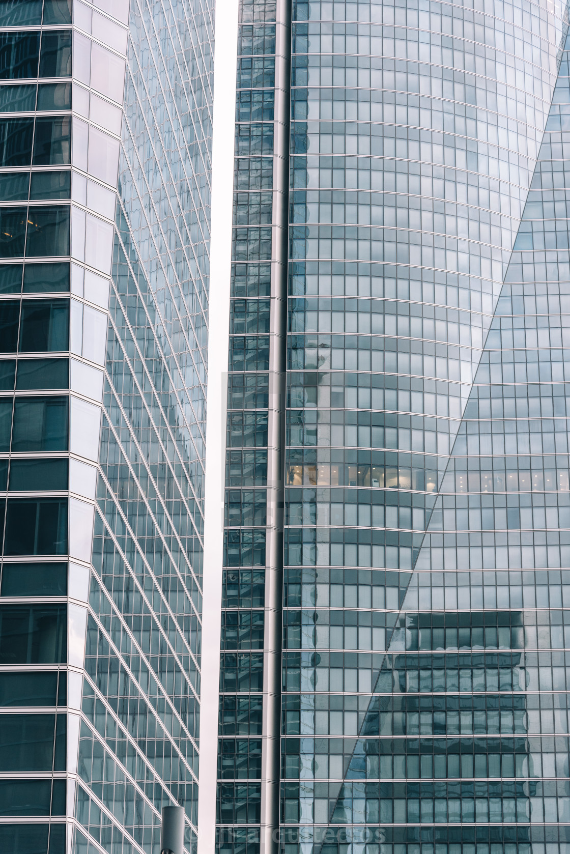 "Low angle view of skyscraper in business district against sky" stock image