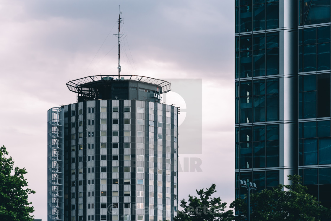 "Low angle view of skyscraper in business district against sky" stock image