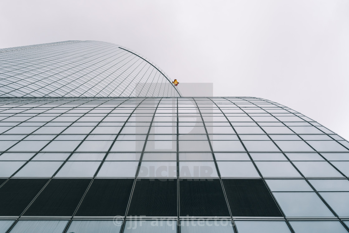 "Low angle view of skyscraper in business district against sky" stock image