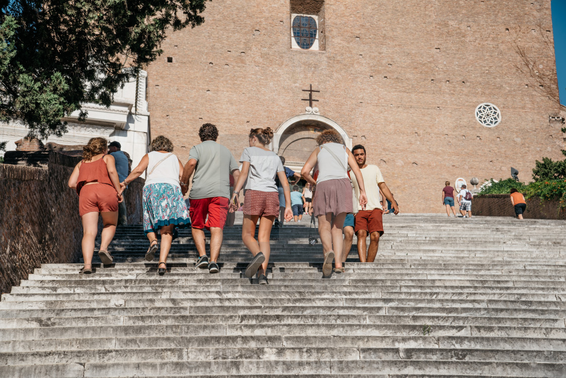 "Tourists climbing the Scalinata dell'Ara Coeli a sunny summer da" stock image