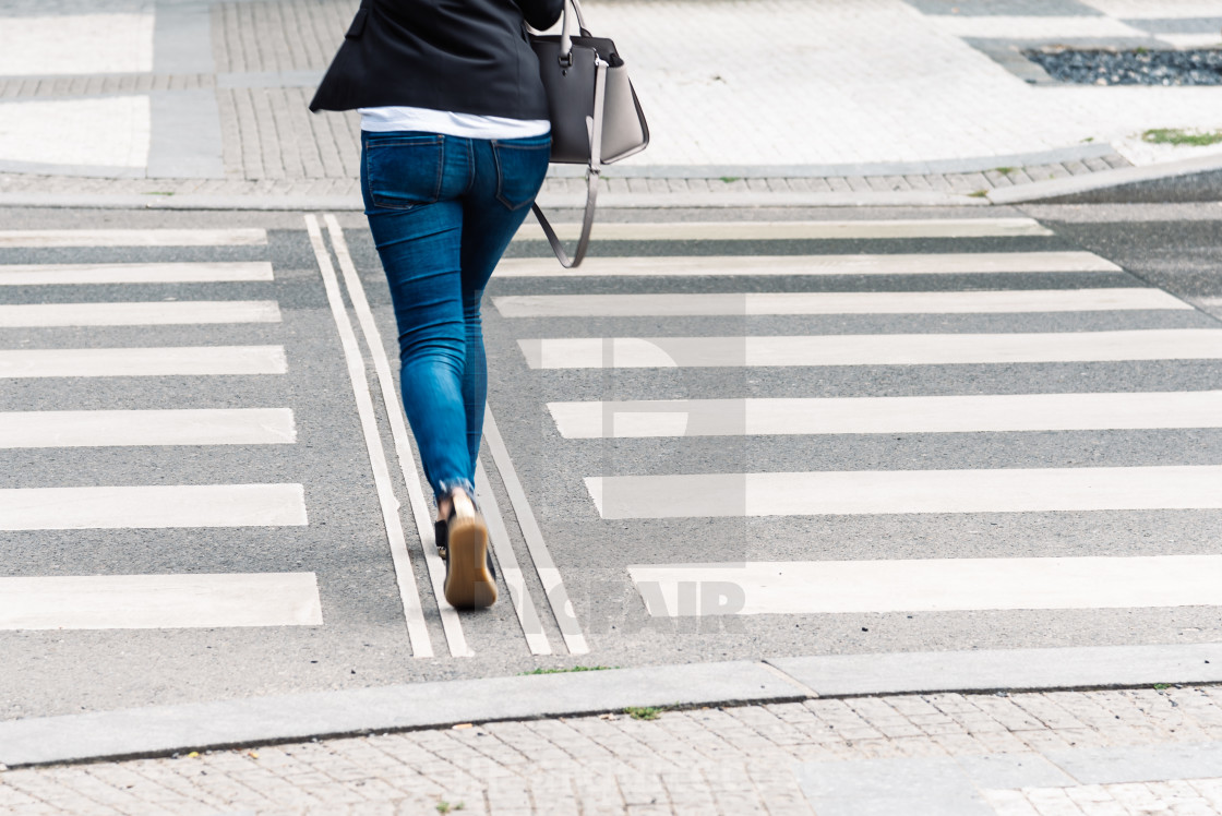 "Young woman wearing casual clothes on zebra crossing" stock image