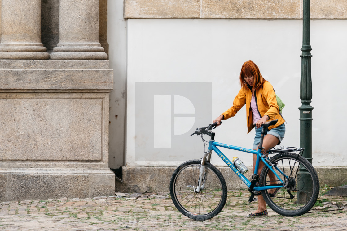 "Woman with bicycle in the street of Prague" stock image