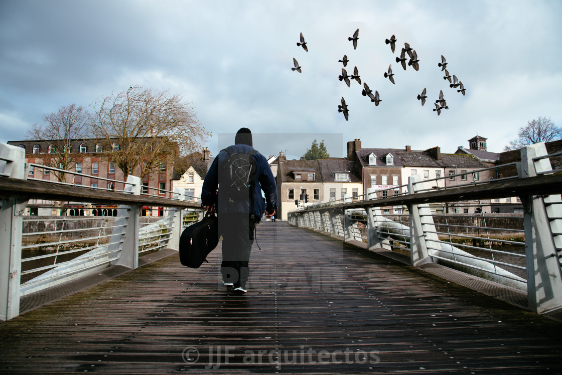 "Beggar crossing a bridge in Cork" stock image