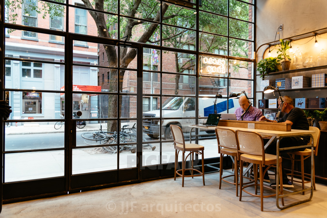 "Male professionals working at cafe in New York" stock image