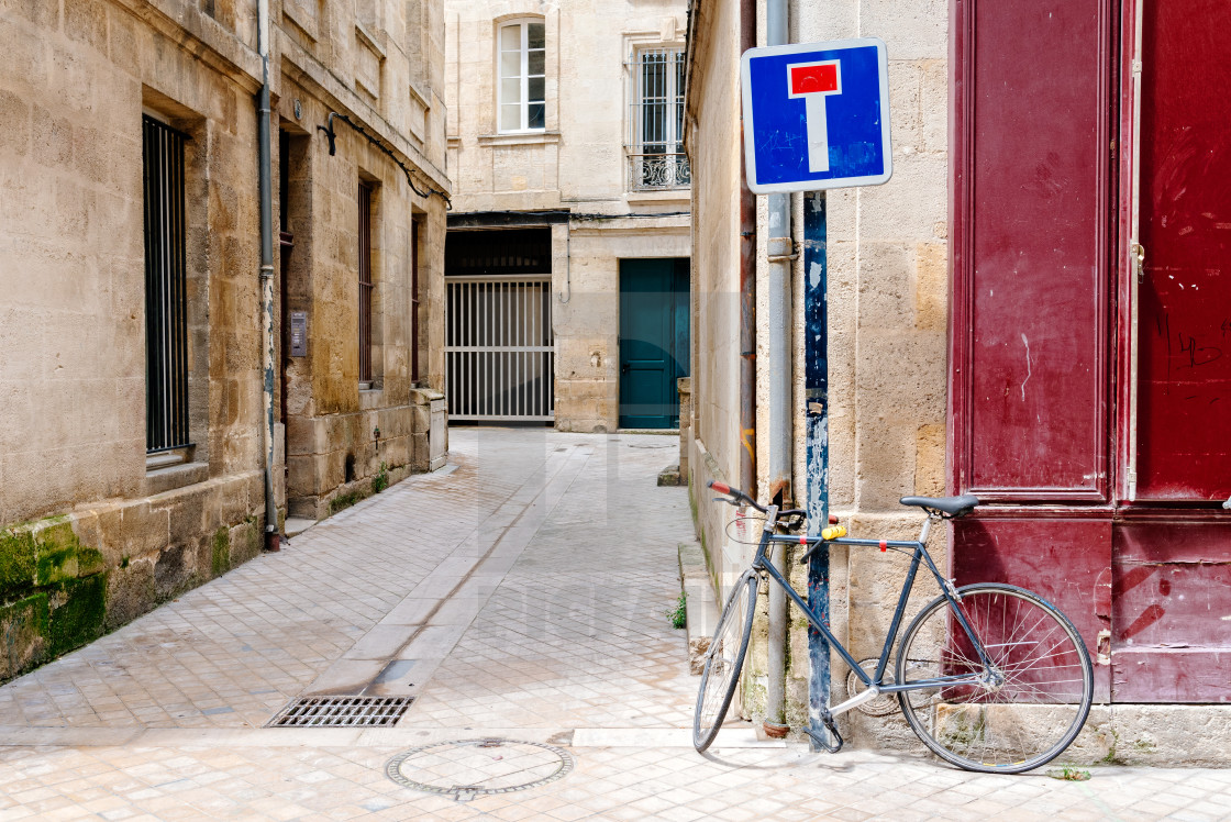 "Bicycle parked in old narrow street of Bordeaux" stock image