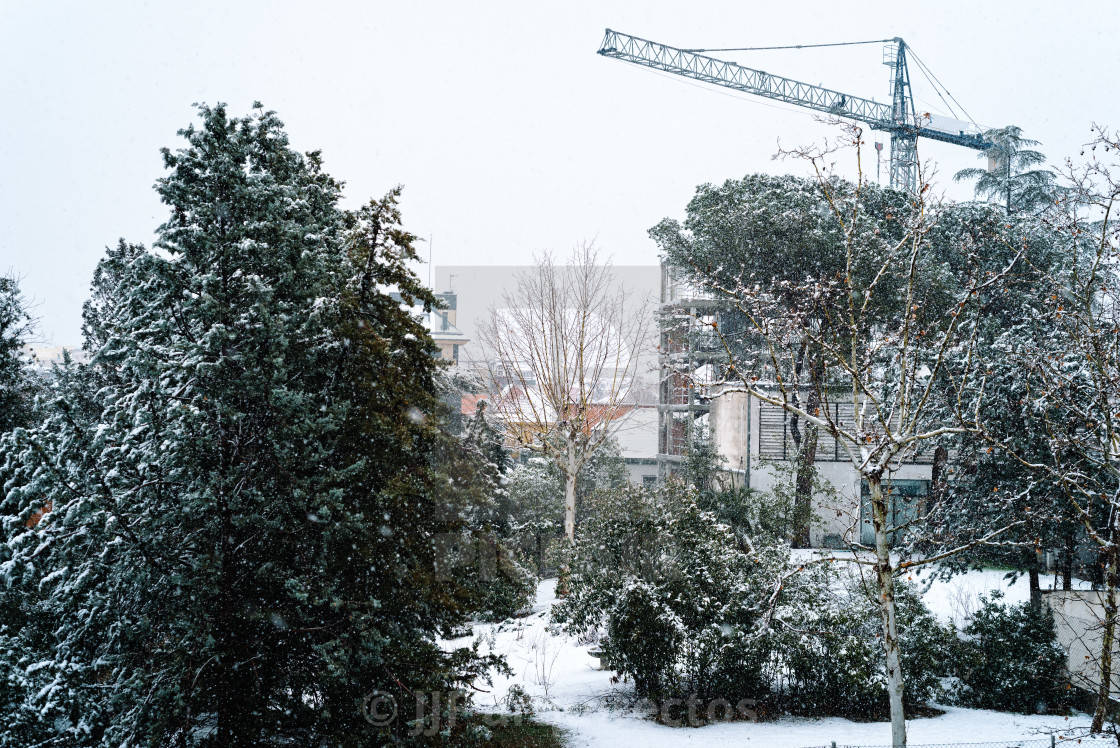 "Snowed construction site with crane in Madrid" stock image