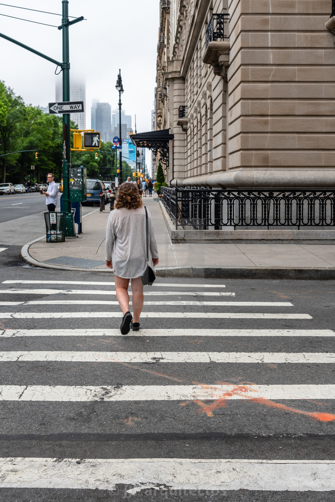 "Unidentified young woman is crossing street in NYC" stock image