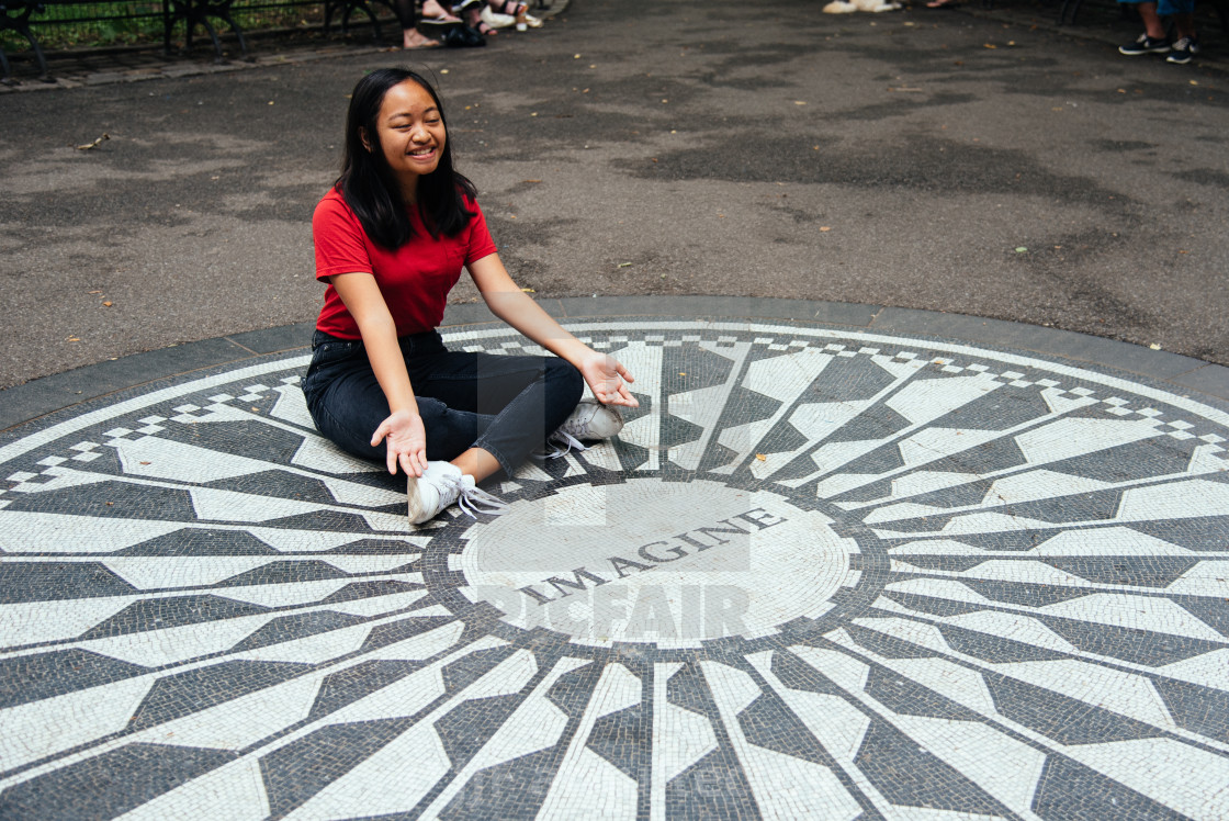 "oung Asian woman sitting on the Imagine mosaic" stock image