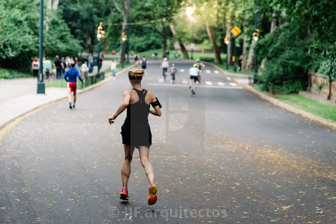 "Rear view of woman running on Central Park" stock image