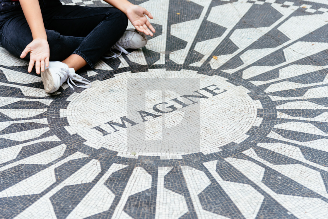 "Young woman sitting on the Imagine mosaic" stock image