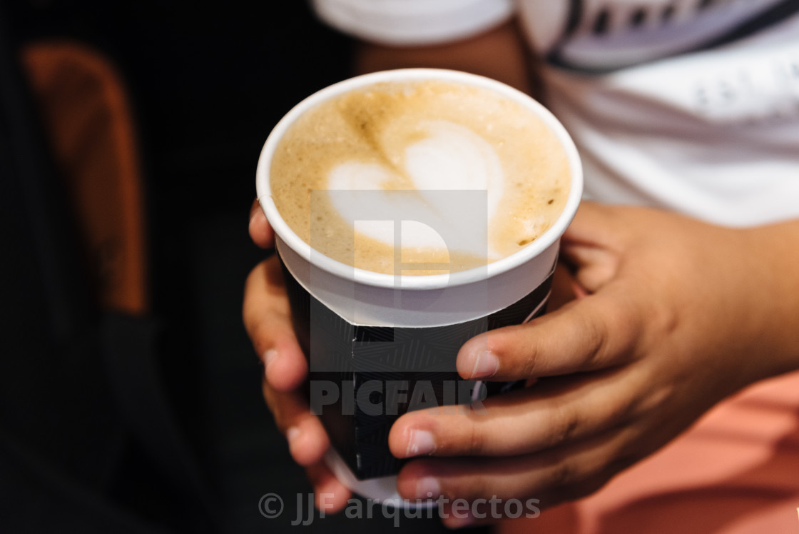 "Young male hands holding a cup of coffee drink" stock image