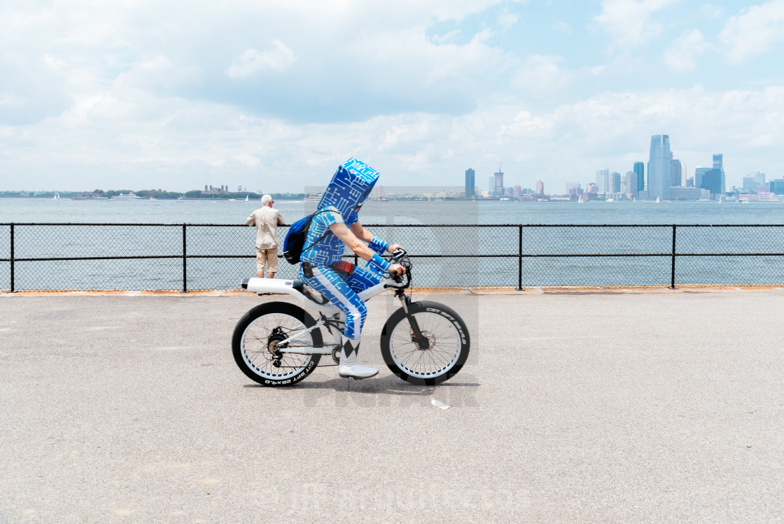 "Man riding a bicycle along promenade in New York City" stock image