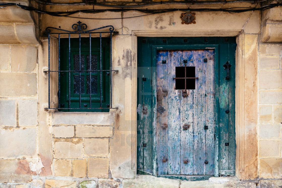 "Old green painted door in stone house" stock image