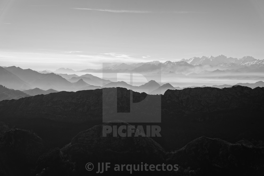 "Scenic view of silhouettes of mountains in the morning mist" stock image