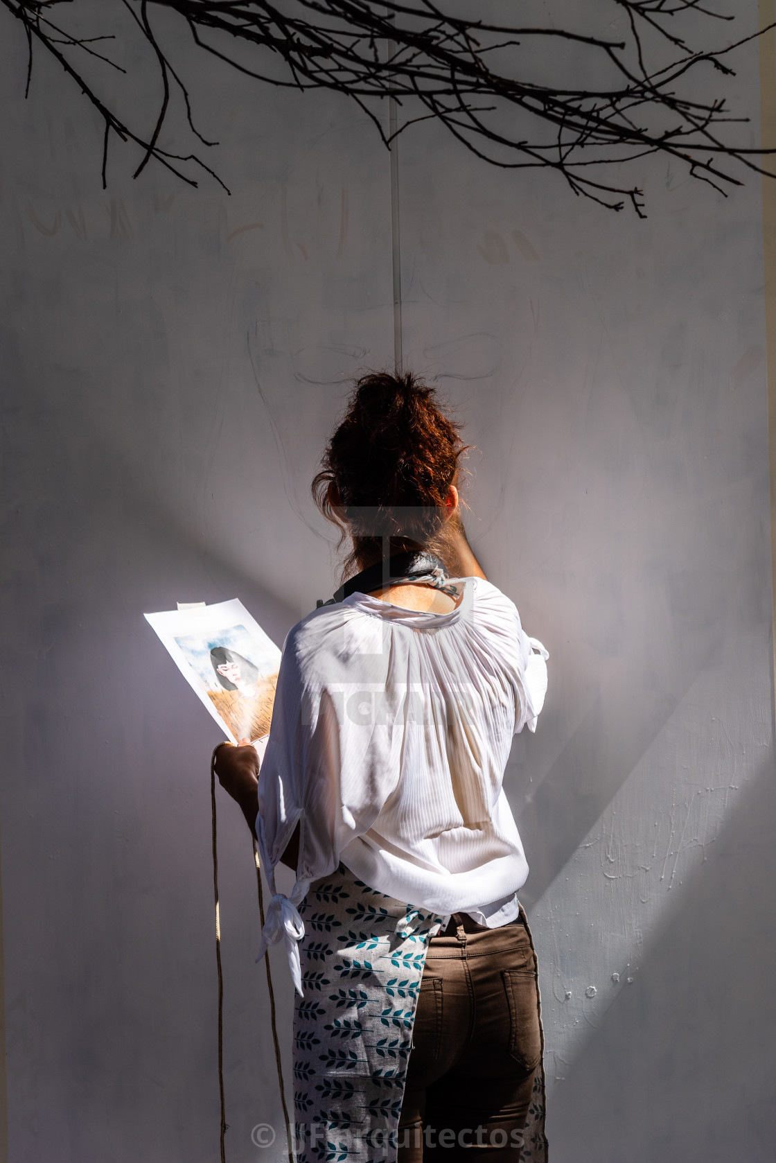 "Artist woman painting storefront in Malasana district in Madrid" stock image