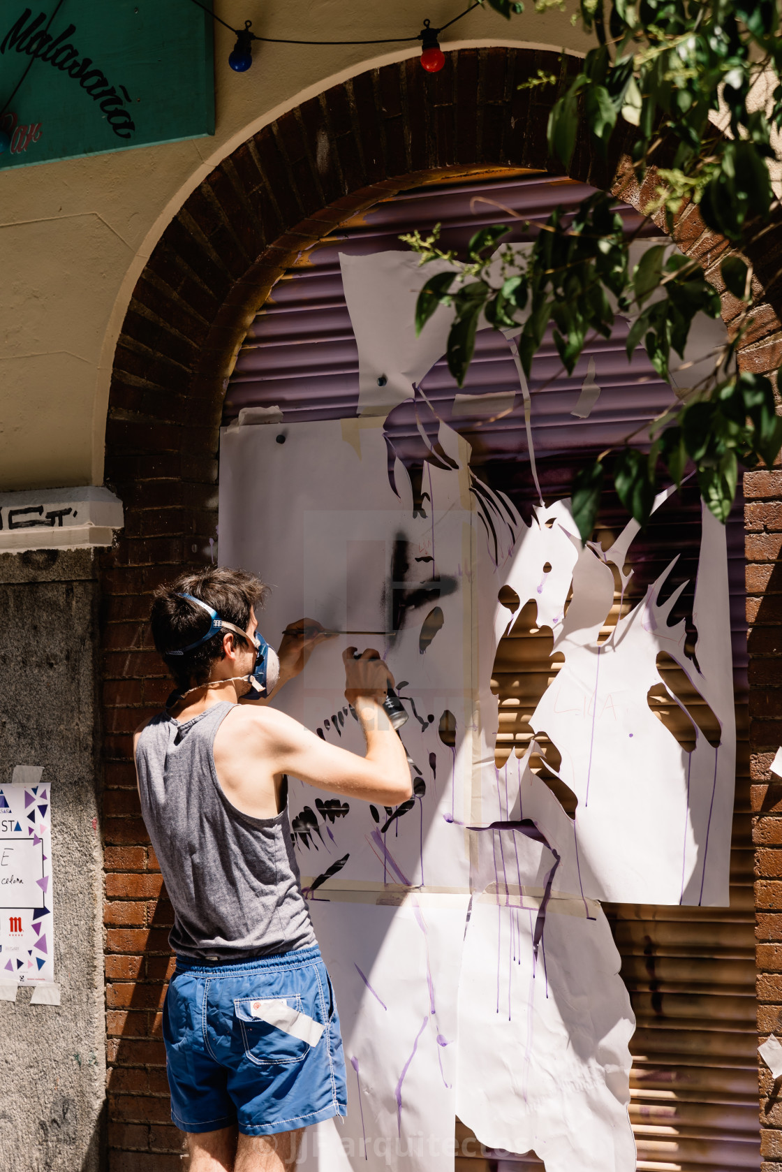 "Artist painting storefront in Malasana district in Madrid" stock image