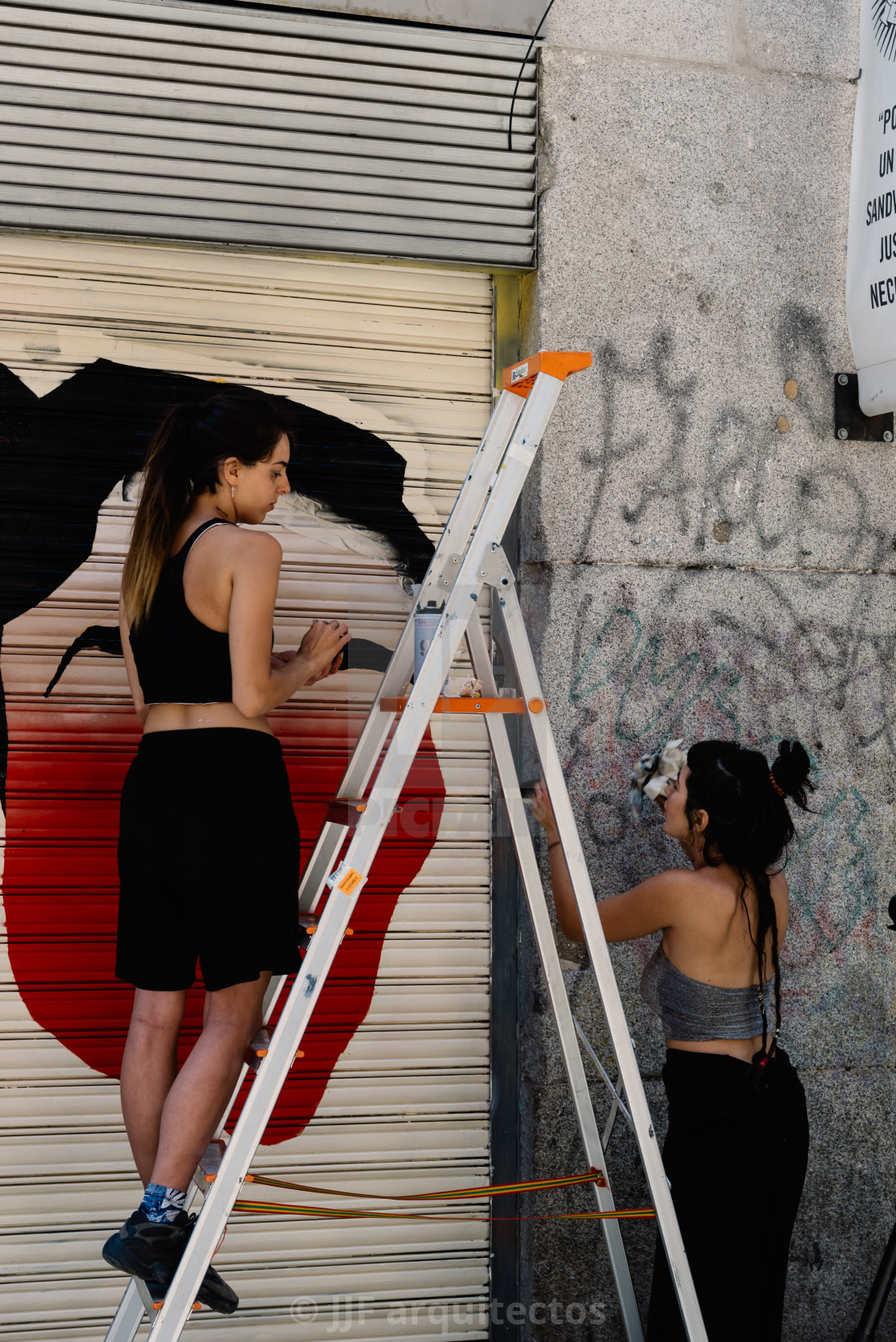 "Artists painting storefront in Malasana district in Madrid" stock image