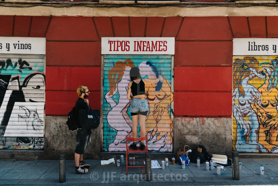 "Artist painting storefront in Malasana district in Madrid" stock image