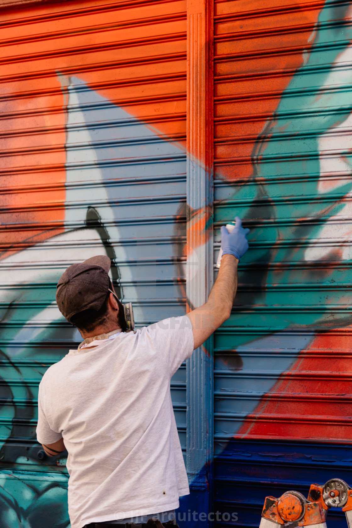 "Artist painting storefront in Malasana district in Madrid" stock image