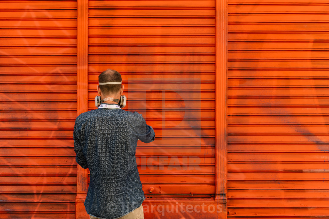 "Artist painting storefront in Malasana district in Madrid" stock image