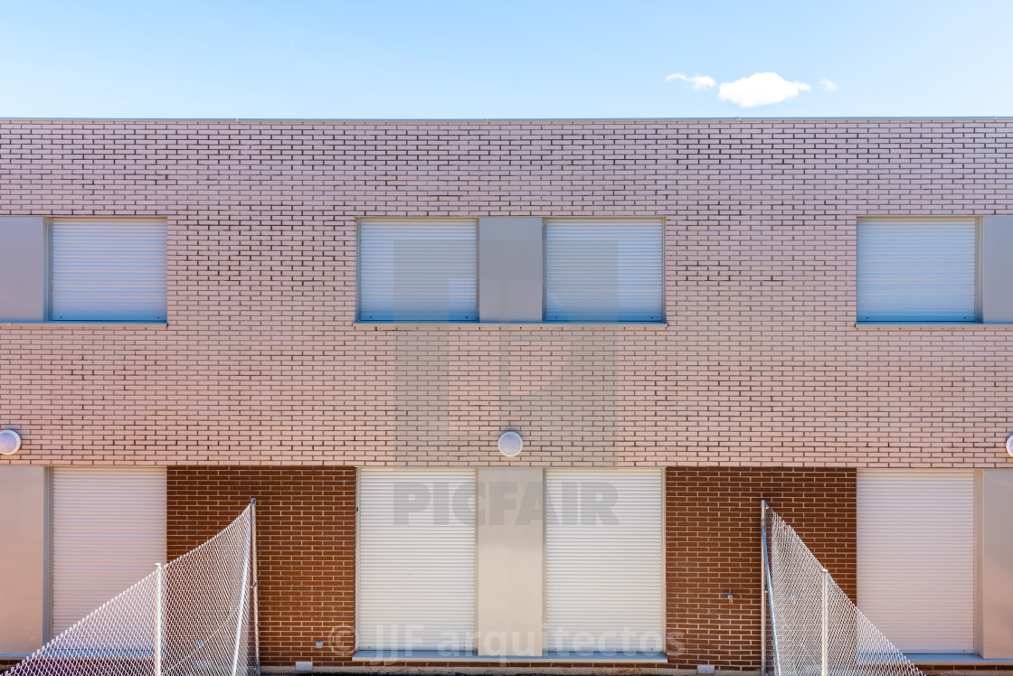 "Exterior view of modern townhouses with brick facade" stock image