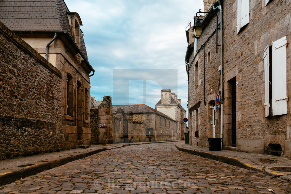 "Stone medieval houses in cobblestoned street in Dinan" stock image