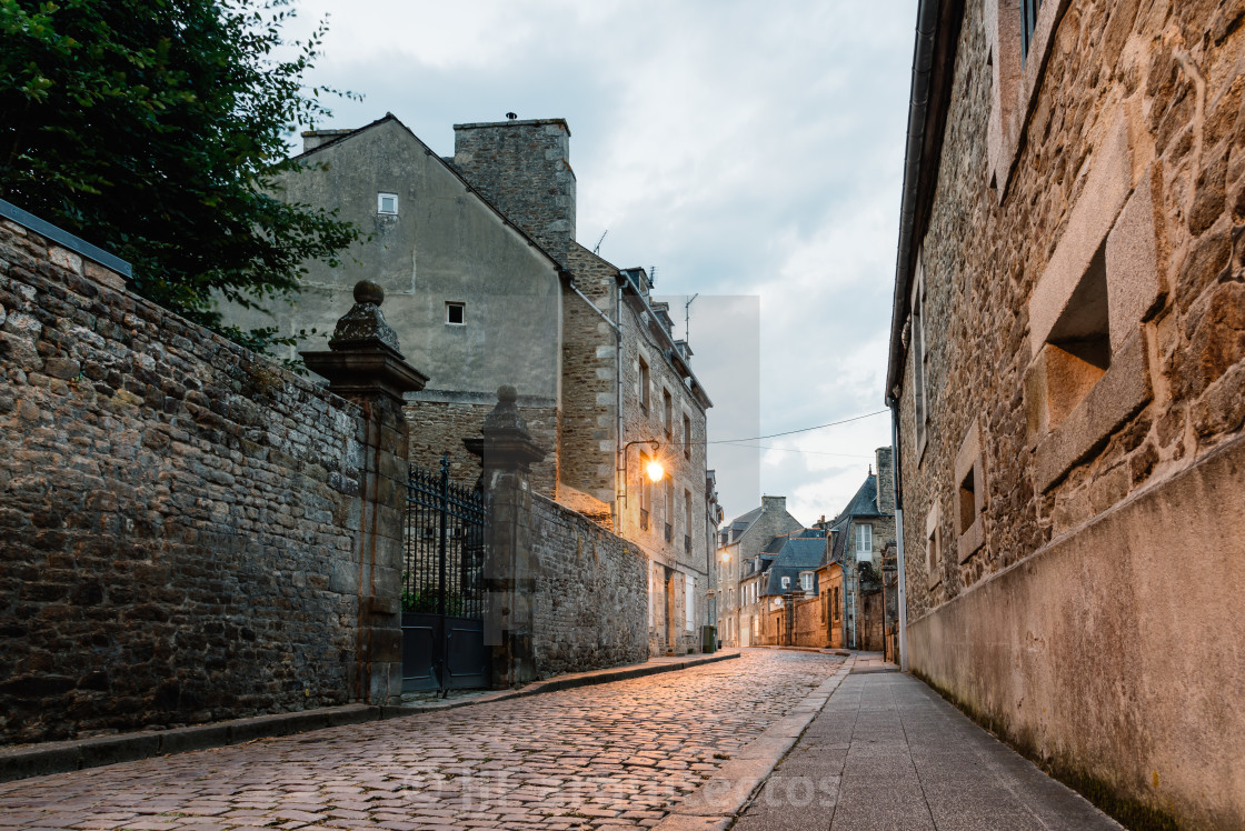 "Stone medieval houses in cobblestoned street in Dinan" stock image