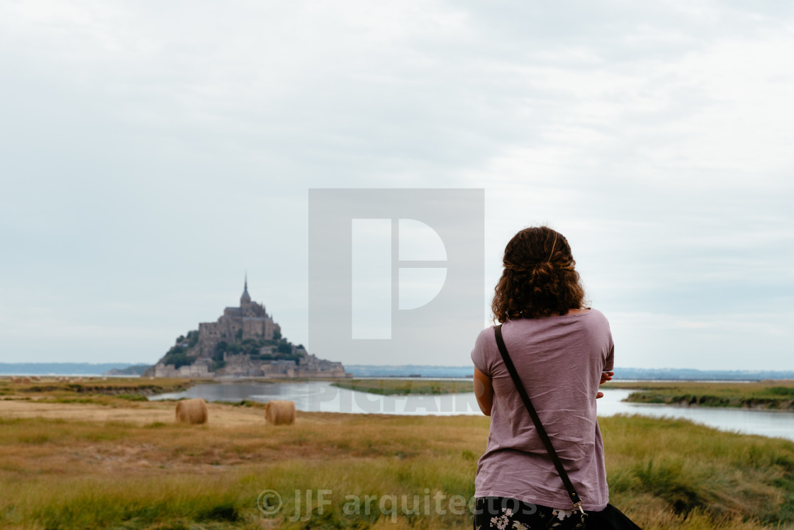 "Rear view of woman watching Mont Saint-Michel" stock image