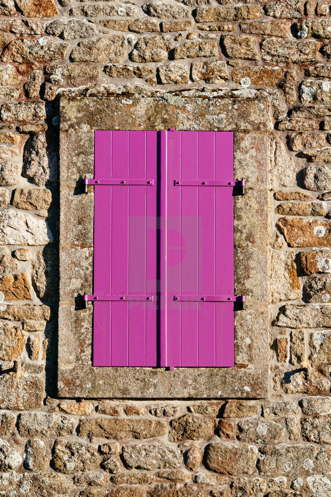 "Old purple closed window in stone wall" stock image