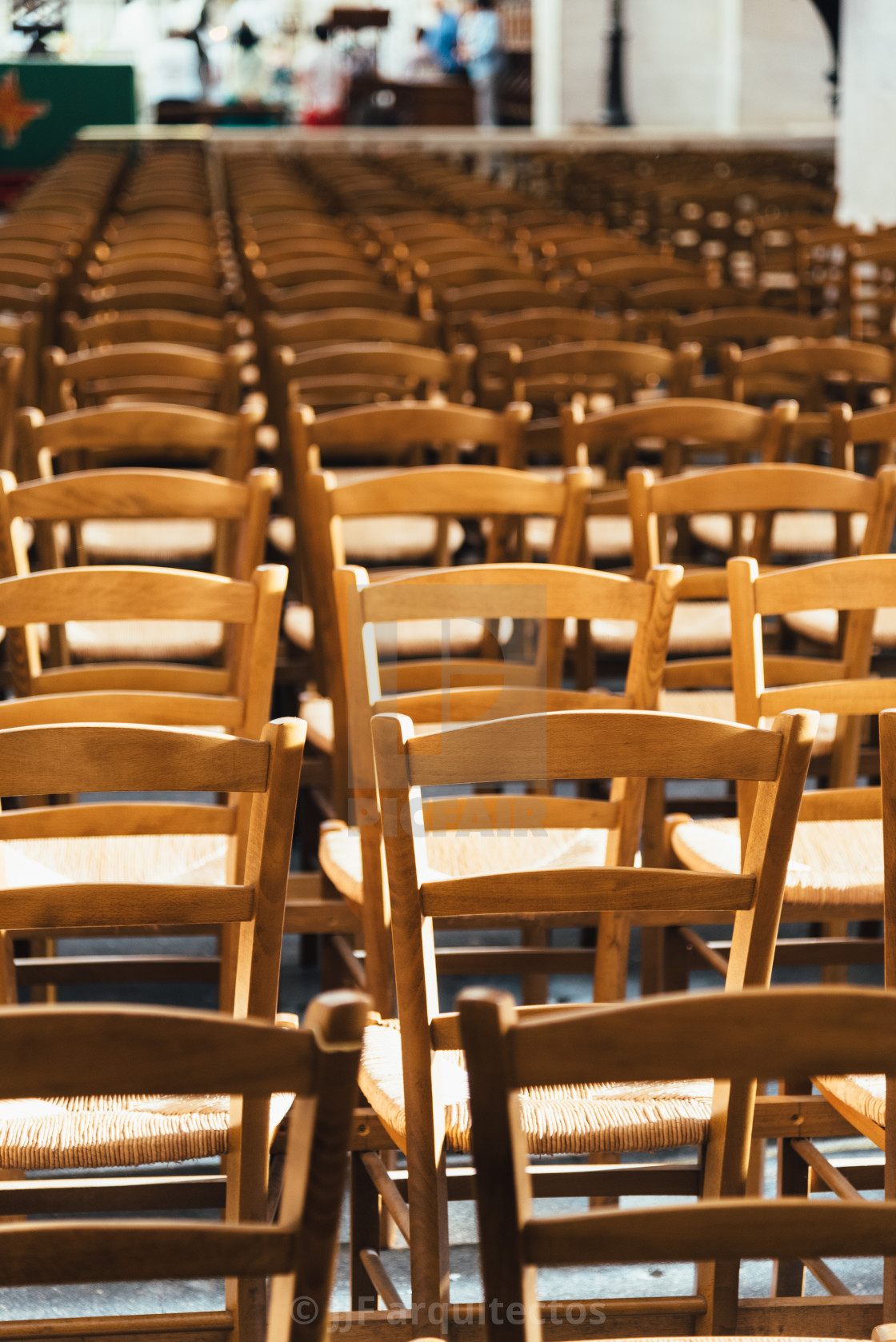 "Empty chairs inside a church forming a pattern" stock image