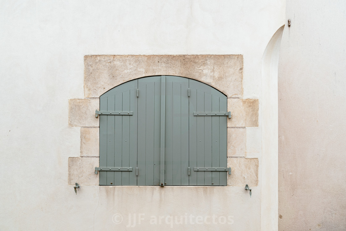 "Old window with wooden light green painted shutters" stock image