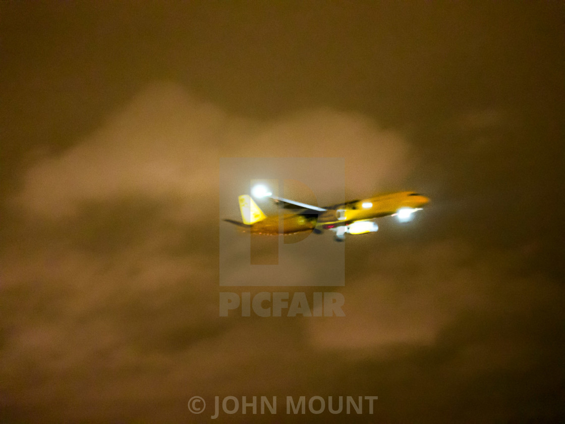 "AIRPLANE FLYING AT NIGHT IN THE CLOUDS" stock image
