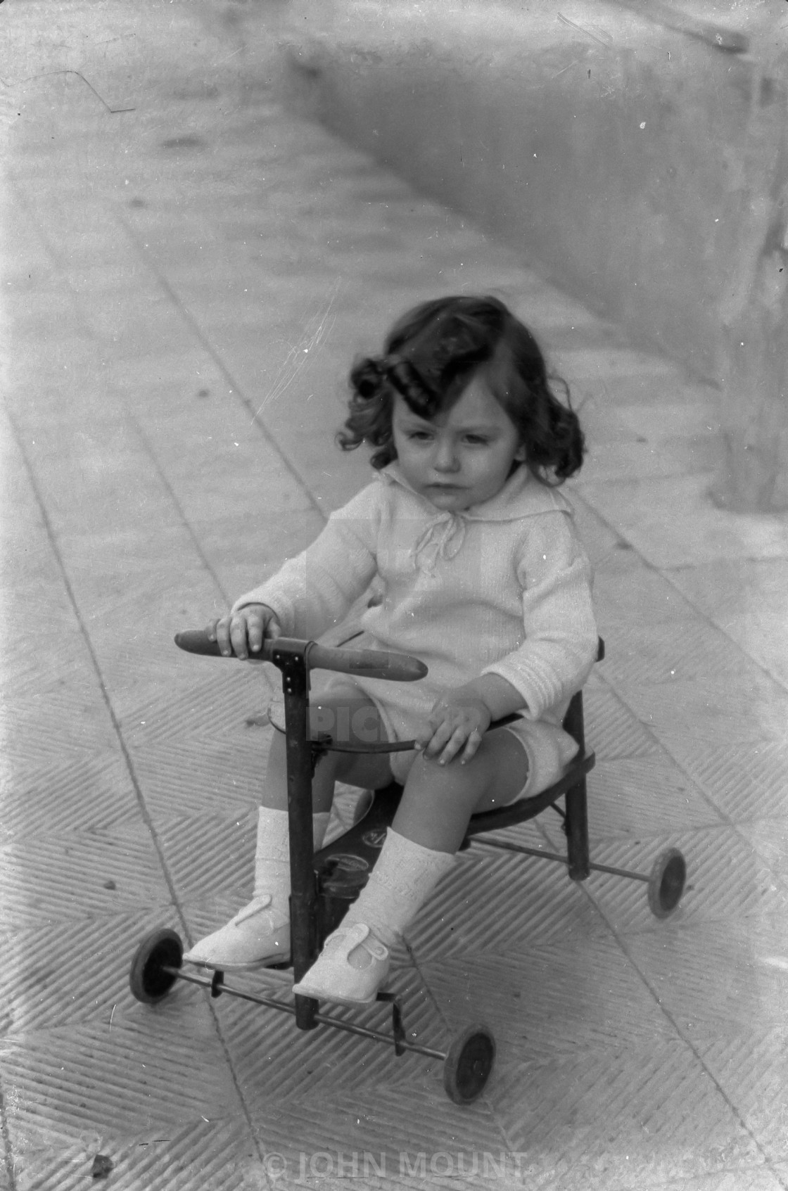 "VINTAGE PORTRAIT OF LITTLE GIRL RIDING A WHEELED TOY" by JOHN MOUNT - £20.00 "VINTAGE PORTRAIT OF LITTLE GIRL RIDING A WHEELED TOY" stock image