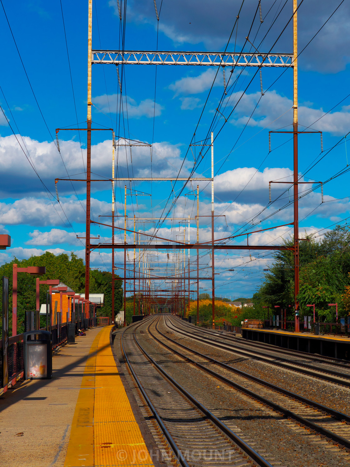 "Train tracks and blue sky" by JOHN MOUNT - $25.10 "Train tracks and blue sky" stock image