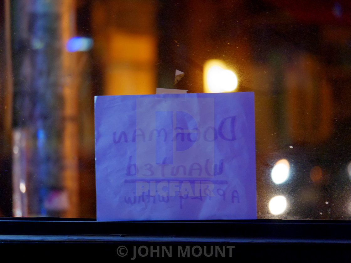 "Doorman Wanted sign in bar window" by JOHN MOUNT - $25.10 "Doorman Wanted sign in bar window" stock image