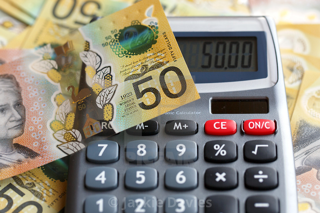 Fifty Australian dollar bill over a calculator. - License, download or print for £4.95 | | Picfair
