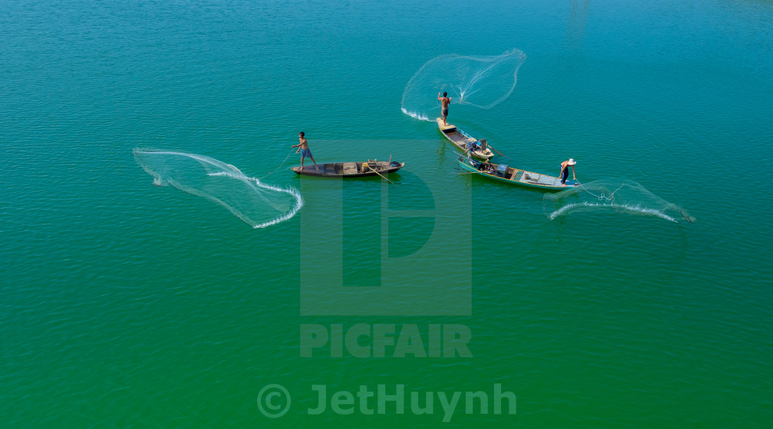 "Throwing fishing net at the lake" stock image