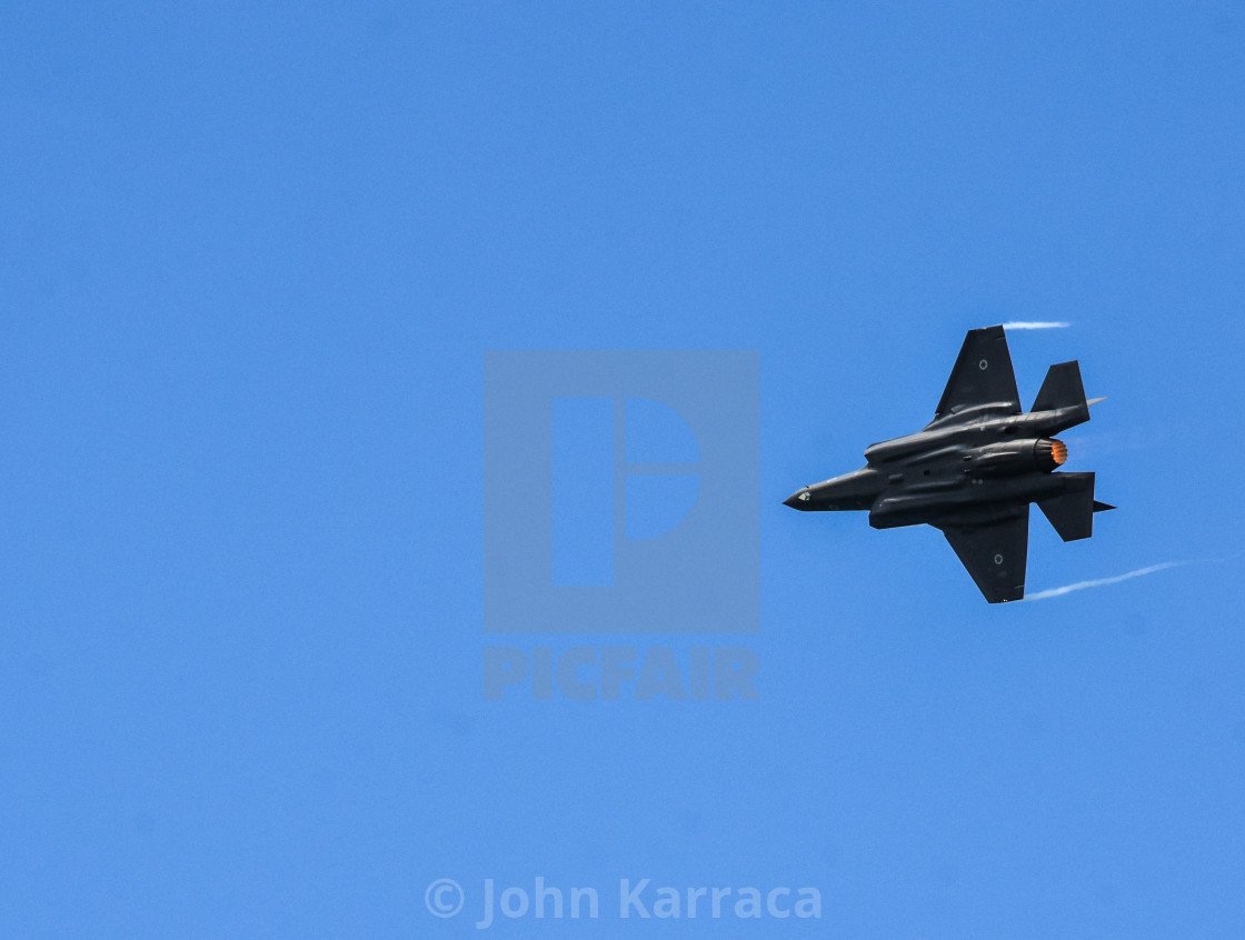 "aeroshow of a f35 produced in Italy in acrobatic evolution" by John Karraca - $4.58 "aeroshow of a f35 produced in Italy in acrobatic evolution" stock image