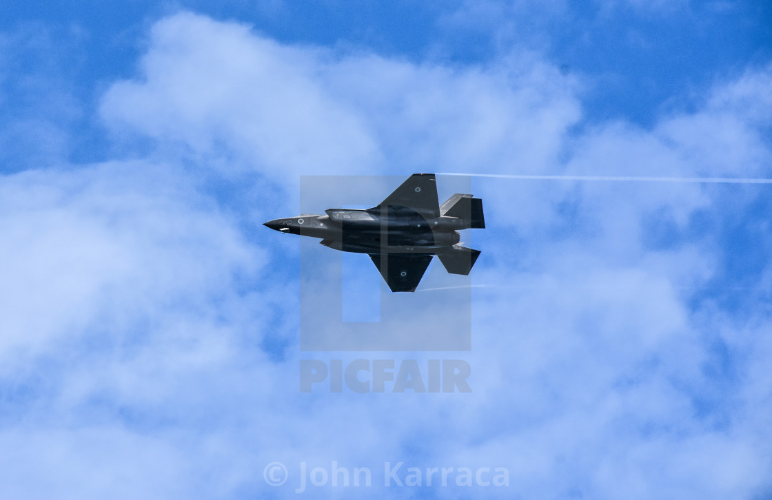 "aeroshow of a f35 produced in Italy in acrobatic evolution" by John Karraca - $4.58 "aeroshow of a f35 produced in Italy in acrobatic evolution" stock image